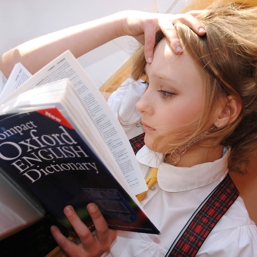 girl reading a dictionary